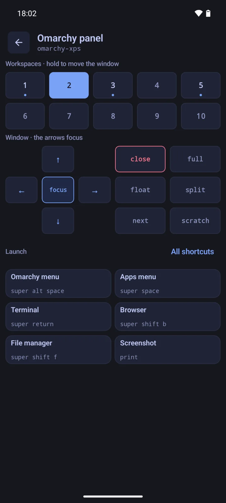 The Omarchy panel with workspaces 1 to 10, the window controls, and the launch shortcuts with their key bindings.